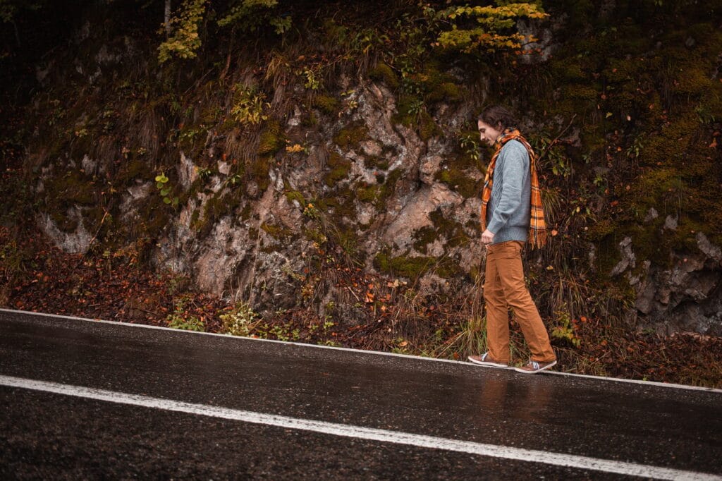 Male Loneliness and the Incel Ideology: Hate Feels Like Family depicted in an image of lonely man on road, concept of loneliness, depression, thoughtfulness. Autumn, mountains, beautiful