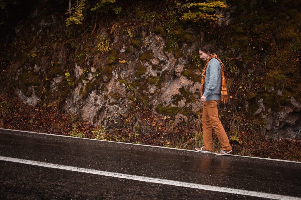 Male loneliness and the incel ideology: hate feels like family depicted in an image of lonely man on road, concept of loneliness, depression, thoughtfulness. Autumn, mountains, beautiful