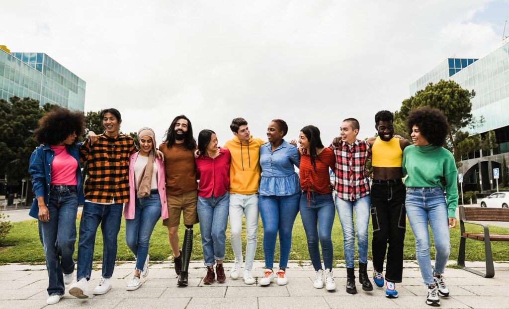 Image depiction of About 355 identity based words censored by u. S. Administration under trump (2025-present)-diverse group having fun walking together by the city - main focus on center guy face