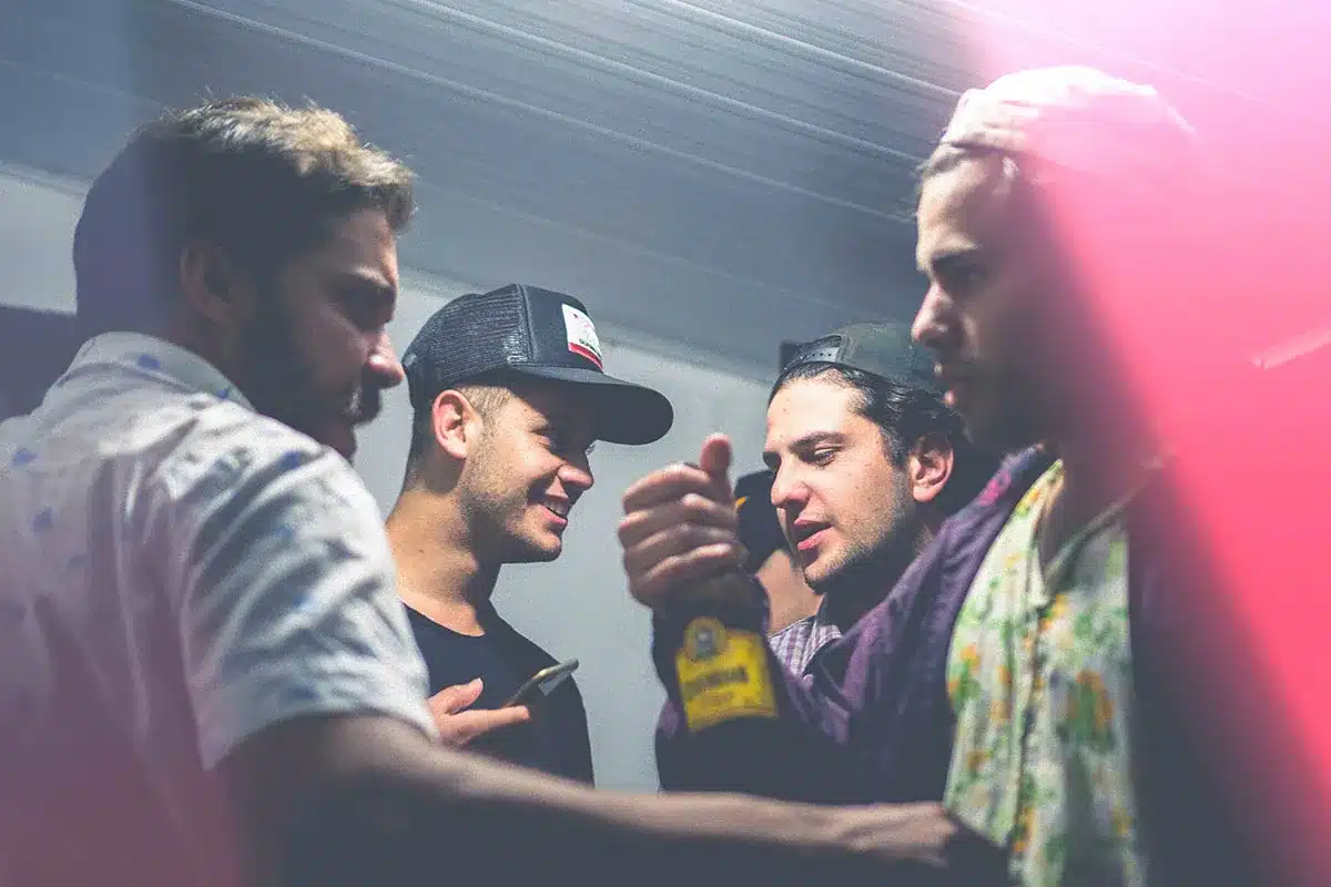Masculinity: group of young men socializing with alcohol in a dimly lit room