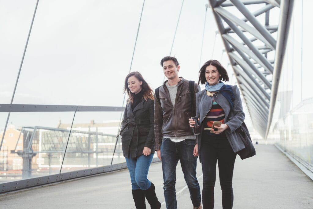 Three people walking outdoor having fun