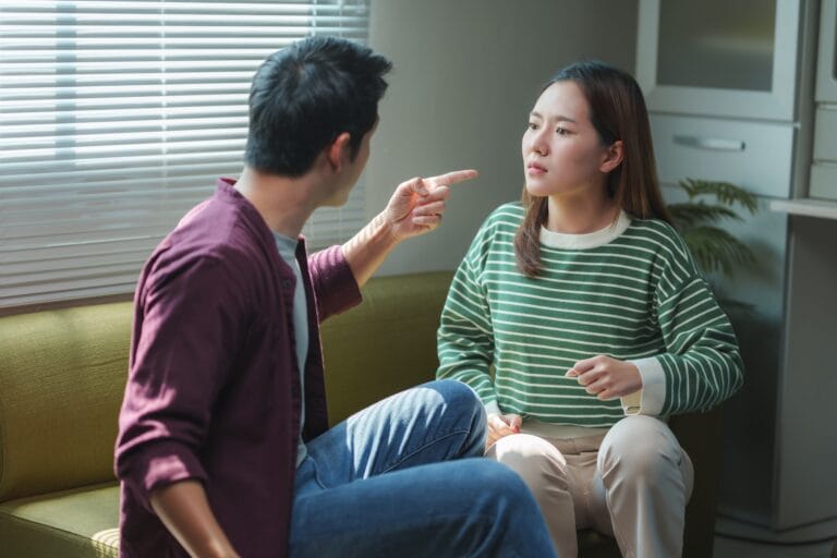 Young asian couple arguing and having relationship problems at home