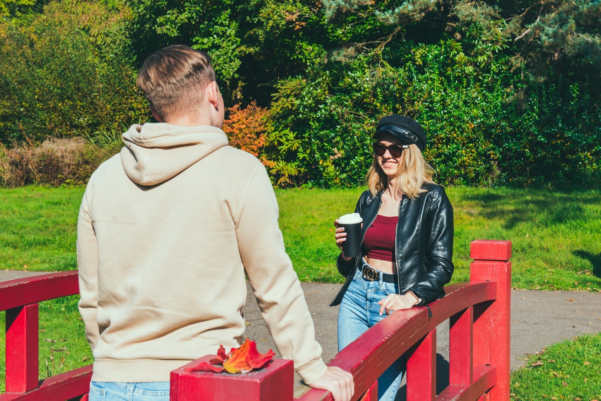 Young people communicating outdoor following social distancing rules. Date in the park