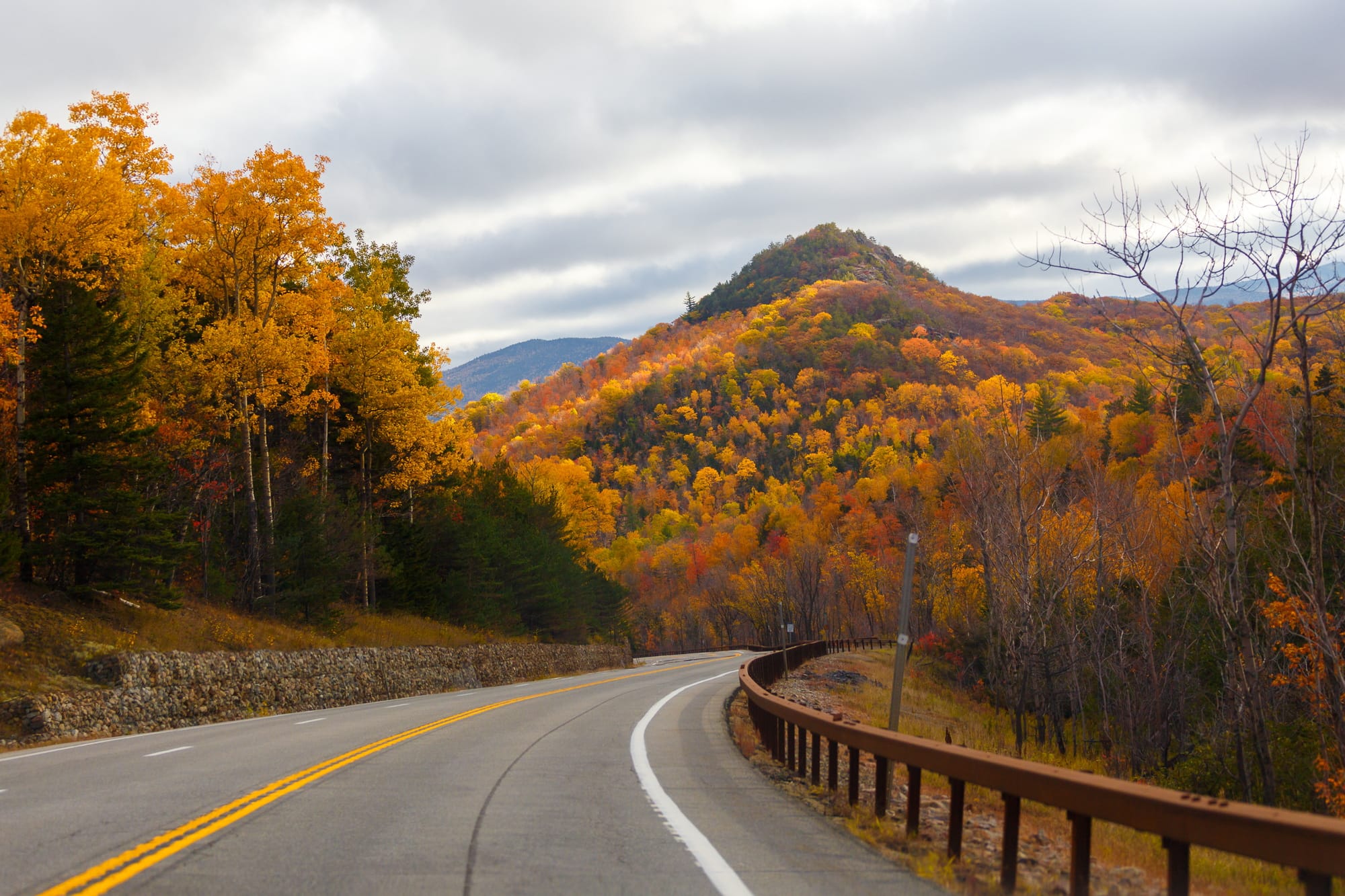 Winding Road Through Autumn Trees with Fall Colors in New England