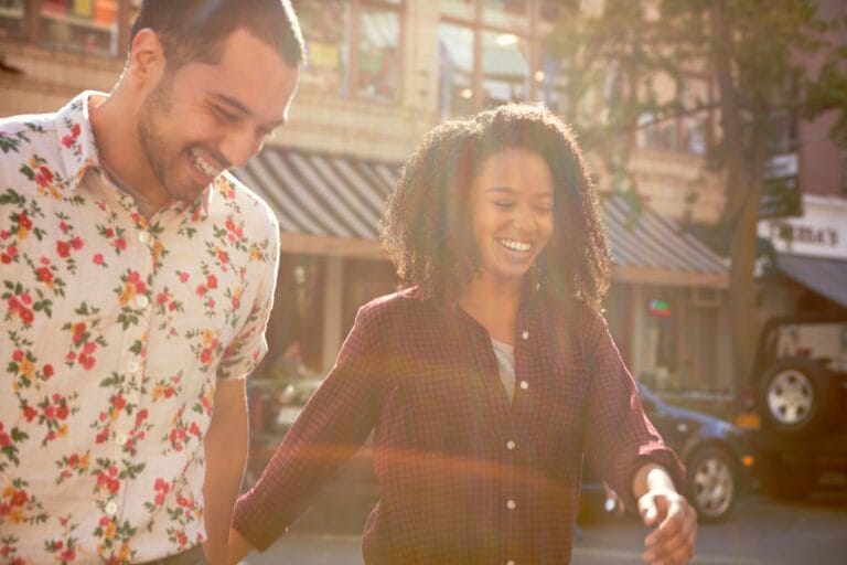 Young Couple Crossing Urban Street In New York City
