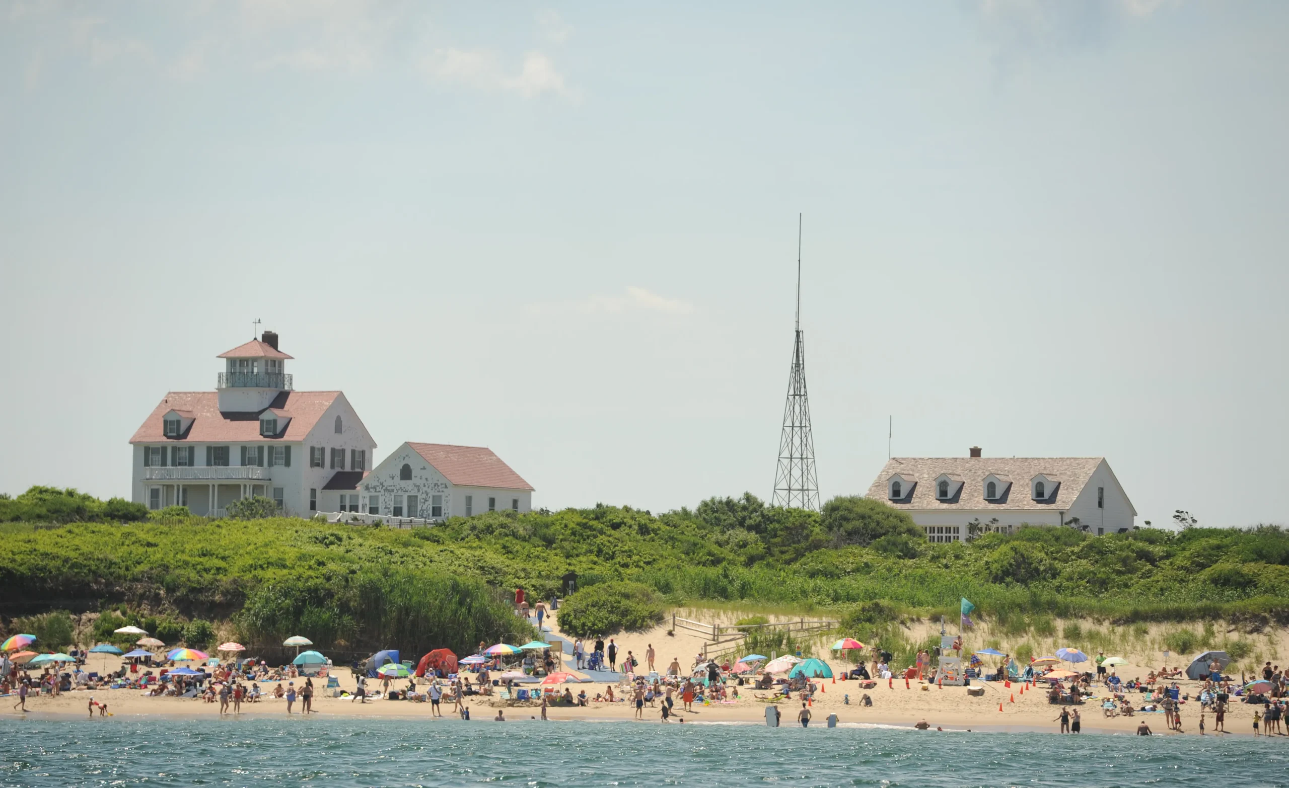 Coast guard beach in eastham, cape cod, showing historic coast guard buildings and a sandy shoreline where people gather, later a popular spot for a winter beach walk date.